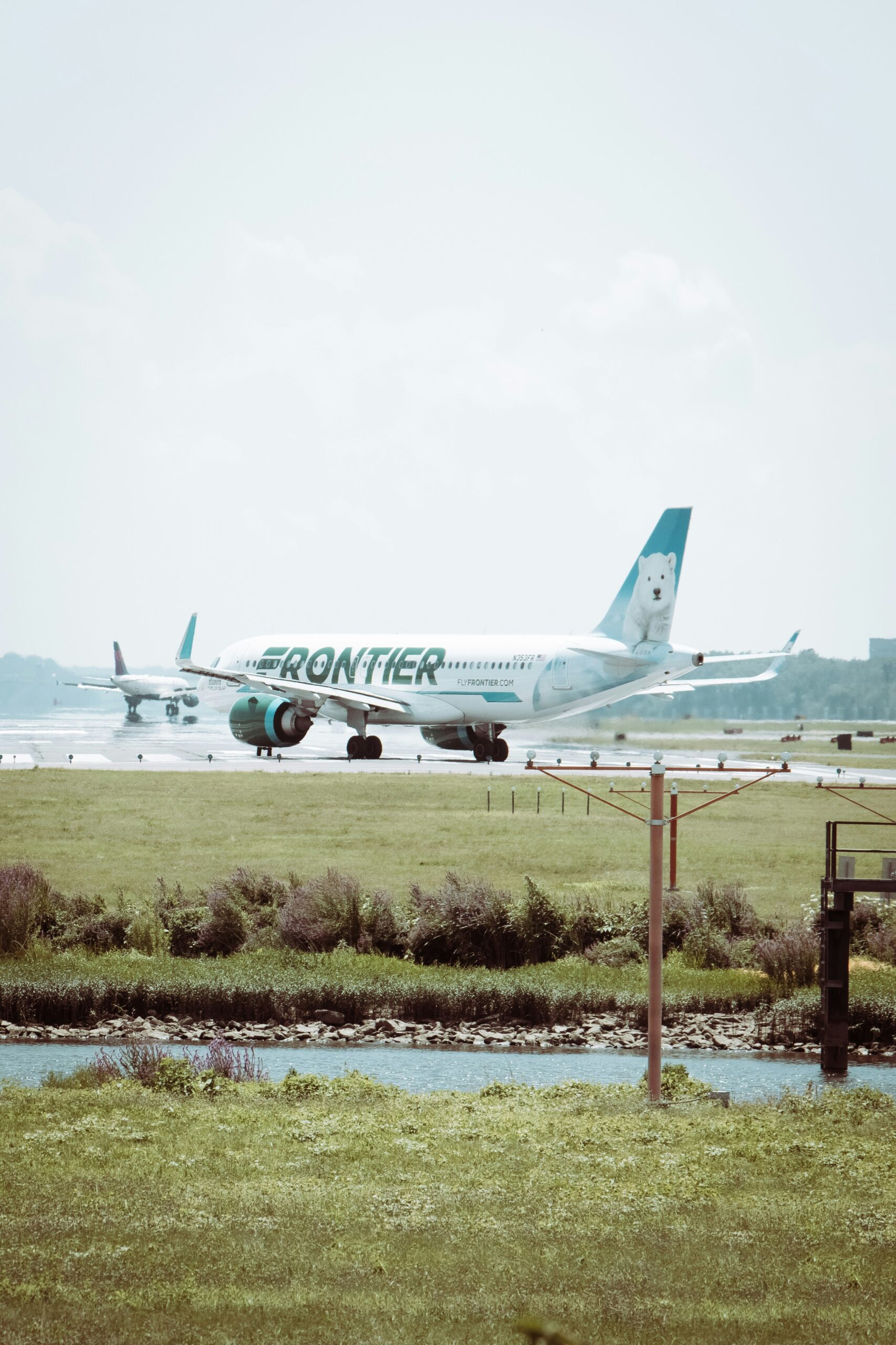 white passenger plane on green grass field during daytime