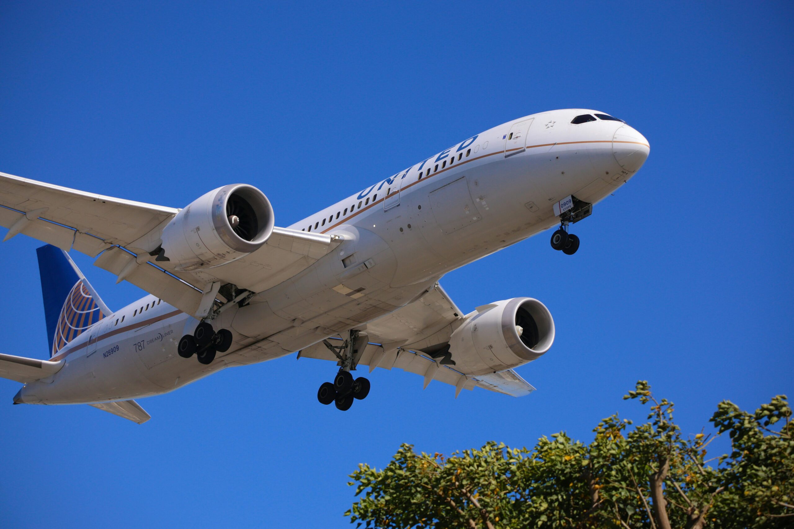 United Airlines airplane flying in the sky.