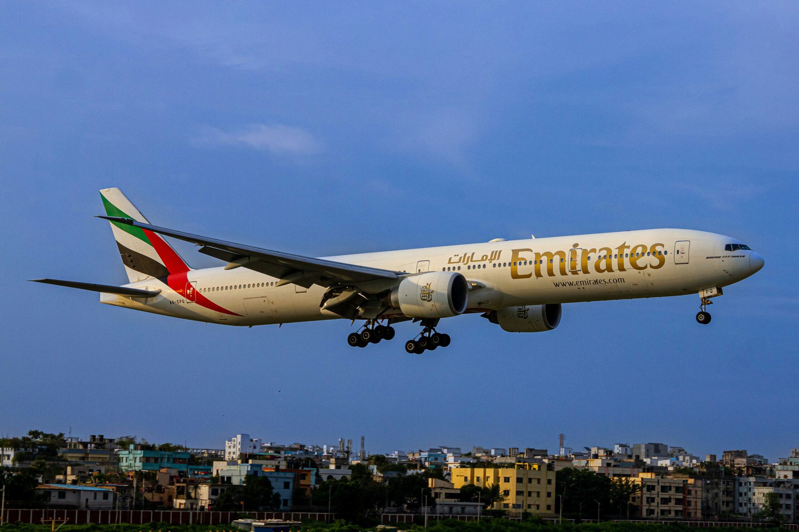 Emirates plane flying through the sky.