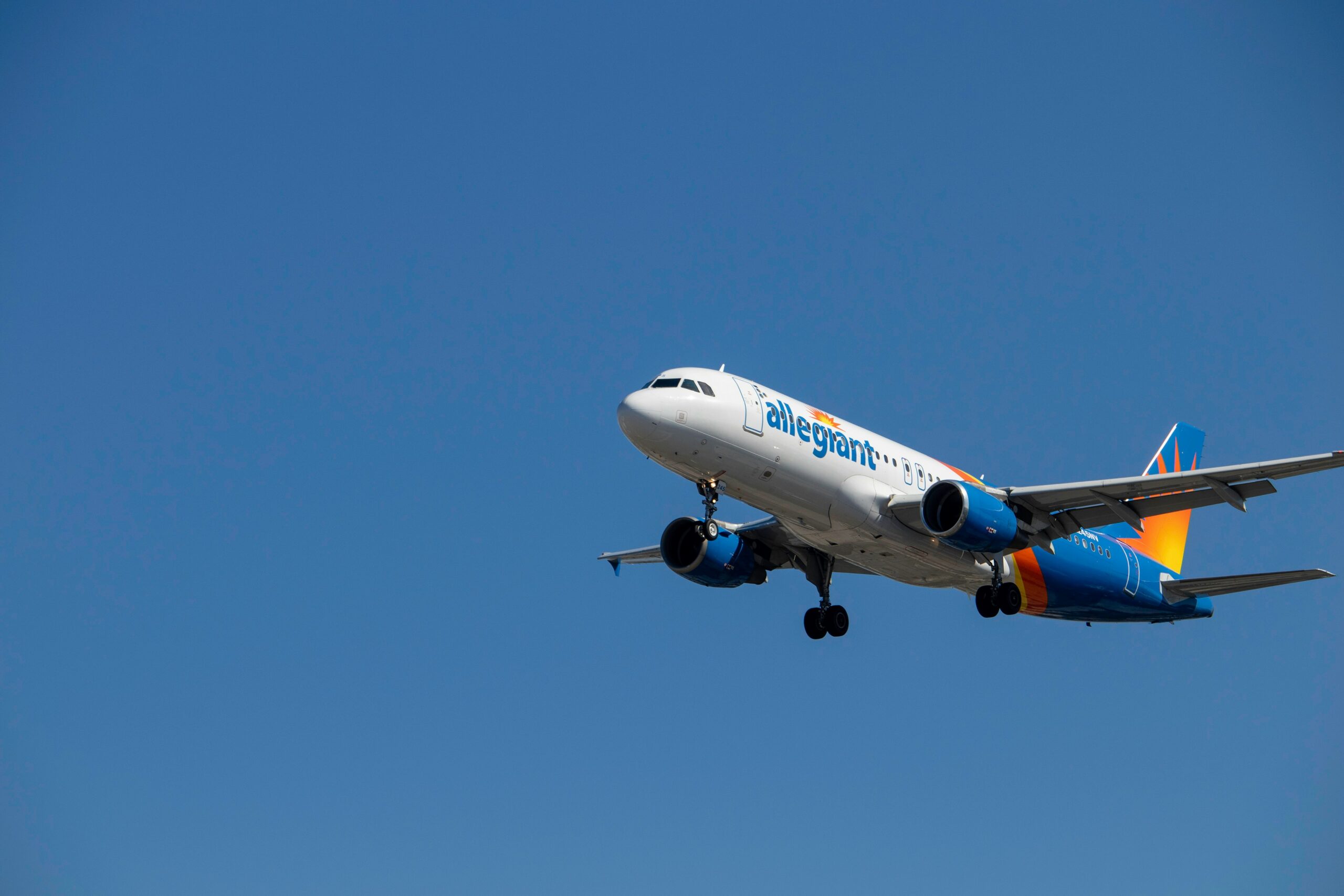 Allegiant Air plane flying in the sky.